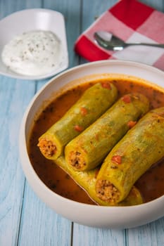 Recipe of stuffed courgette with tomato sauce, Lebanese style, Kouca Mehchi bi Banadoura, with Greek yogurt. High quality photo