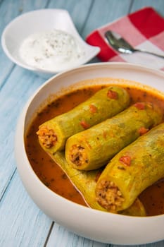 Recipe of stuffed courgette with tomato sauce, Lebanese style, Kouca Mehchi bi Banadoura, with Greek yogurt. High quality photo