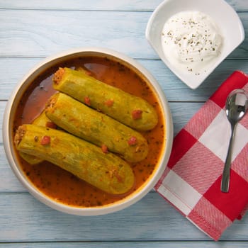 Recipe of stuffed courgette with tomato sauce, Lebanese style, Kouca Mehchi bi Banadoura, with Greek yogurt. High quality photo