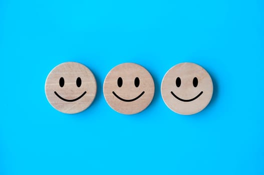 Happy emotion faces on wooden cubes. Customer satisfaction and evaluation concept