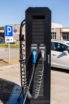 Electric vehicle Charging station. plug-in power cable. A power supply for charging an electric vehicle. Eco electric concept. Car charger. Alternative fuel. green energy technology