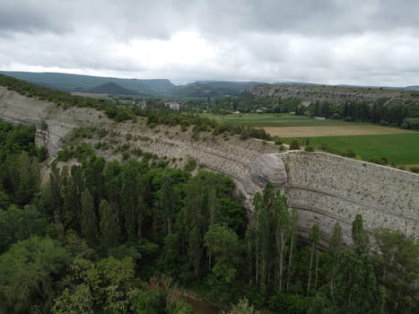 lush green farm field with rocky cliffs in the distance. The video highlights the beauty of rural areas and the agricultural process.