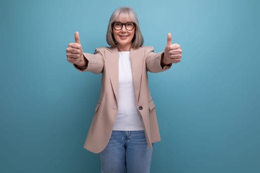 smiling middle-aged woman in a stylish jacket smiling on a bright studio background.