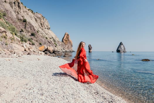 Woman travel sea. Happy tourist taking picture outdoors for memories. Woman traveler looks at the edge of the cliff on the sea bay of mountains, sharing travel adventure journey.