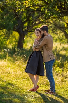 man hugging his girlfriend in nature