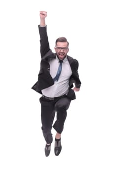 in full growth. happy dancing young businessman. isolated on white background