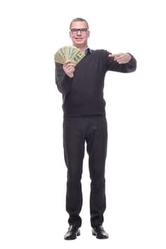 Smiling business man in black clothes holding money in hand and looking at camera. Isolated white background