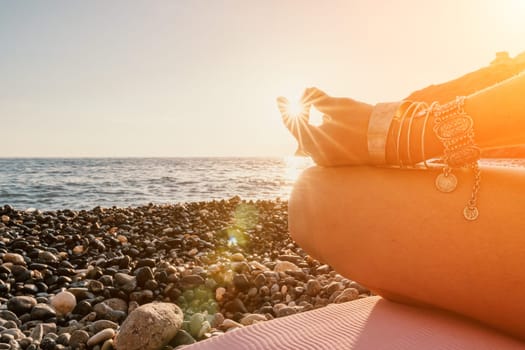 Young woman in swimsuit with long hair practicing stretching outdoors on yoga mat by the sea on a sunny day. Women's yoga fitness pilates routine. Healthy lifestyle, harmony and meditation concept.