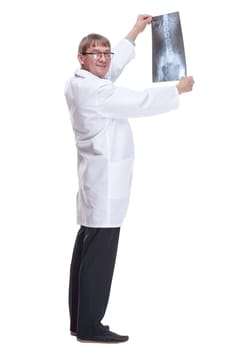 side view. doctor looking at an x-ray. isolated on a white background.