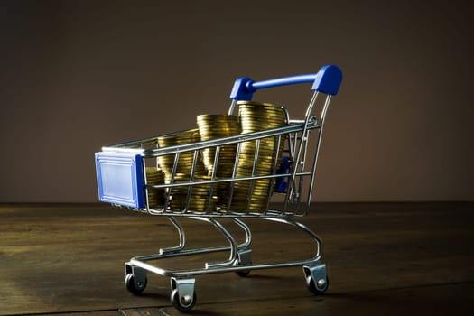 A Shopping cart full of coins as a concept payday loan.