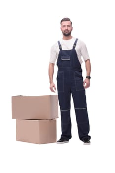 in full growth. smiling man standing near cardboard boxes. photo with copy space