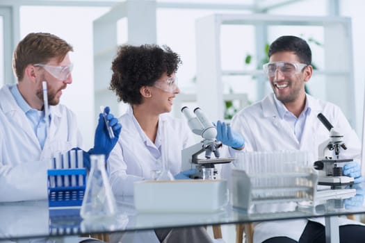 Team of Scientists Working Using Microscope, Analysing Microbiology Samples