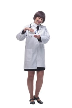 in full growth. female medic using sanitizer . isolated on a white background.
