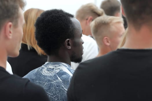 cropped image of a youth group pointing up. photo with copy space