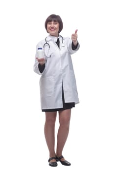 in full growth. female medic with sanitizer in hand showing thumbs up . isolated on a white background.