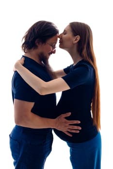 Photo of cheerful young man standing with his pregnant woman isolated over white background wall. beautiful young couple expecting baby standing together and touching belly