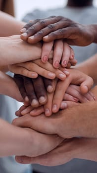 close up. young people making a tower of hands. the concept of unity