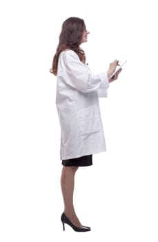 in full growth. female doctor looking at a digital tablet screen . isolated on a white