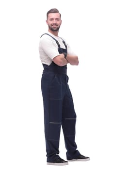 side view. smiling man in overalls looking forward to copy space. isolated on white background