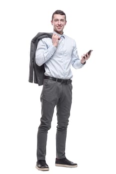 in full growth. smiling business man with a smartphone . isolated on a white background.