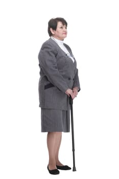 in full growth. confident old woman with a walking stick. isolated on a white background.