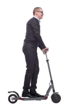 Side view of happy man rides a black kick scooter, isolated on white background.