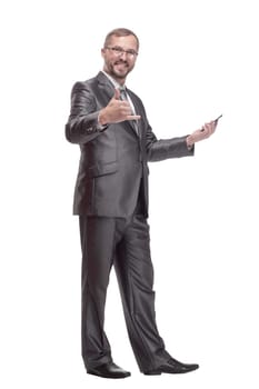 in full growth.Executive business man with a smartphone. isolated on a white background.glasses
