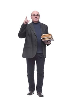 in full growth. senior business man with a stack of books . isolated on a white background
