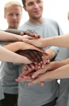 close up. young people making a tower of hands. the concept of unity