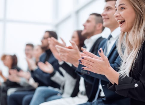 close up. group of employees applauds during a business meeting