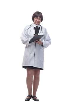 in full growth. female medic with clipboard . isolated on a white background.