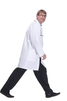 side view. serious doctor in a white coat rushes to the rescue .isolated on a white background.