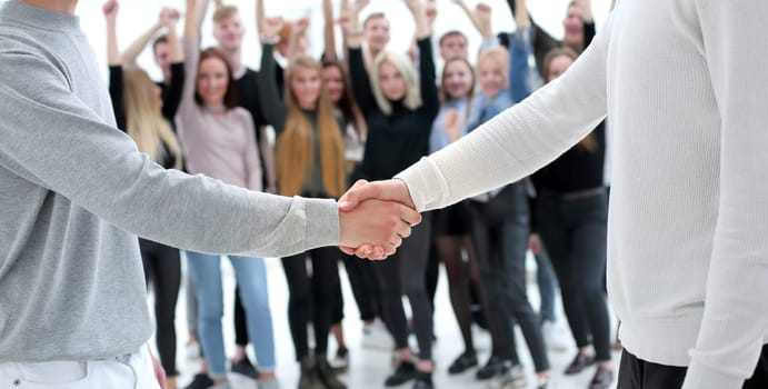 close up. young business people shaking hands with each other. the concept of cooperation