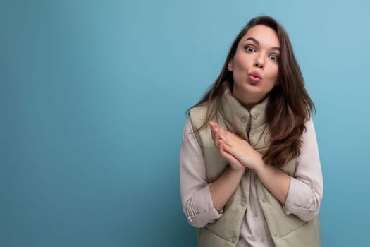 coquettish young brunette female adult in casual outfit flirting on studio background.