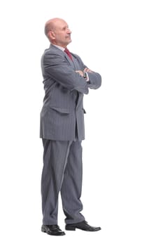 Full length profile portrait of businessman in suit looking at camera isolated on a white background.