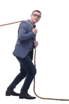 Side view of businessman in suit pulling a rope while standing against white background. Concept of efforts