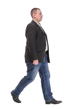 picture of a young business man walking forward on white background. side view of a young businessman walking