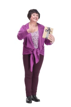 in full growth.happy senior woman with gift box. isolated on a white background.