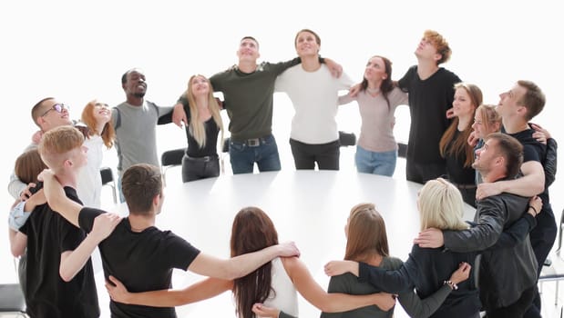 group of young like-minded people standing around a table . photo with copy space