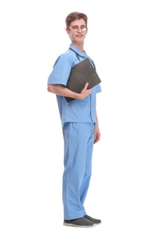 Side view of concentrated male doctor writing reports over white background