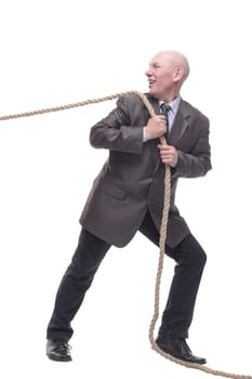 in full growth. business man pulls a rope. isolated on a white background.