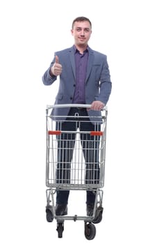 A full length portrait of a man pushing an empty shopping cart isolated on white background