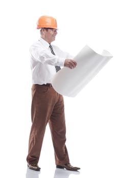in full growth. an architect in a protective helmet reading a drawing. isolated on a white background