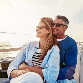 Look at that beautiful view. a couple enjoying a boat cruise out on the ocean