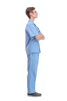 Full length profile shot of a young male doctor in a blue uniform standing and waiting isolated on white background