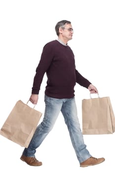 full-length. casual man with shopping bags. isolated on a white background.