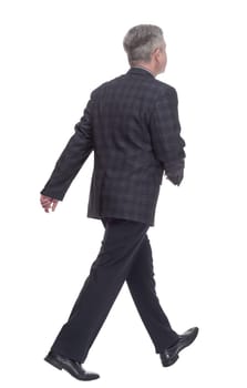 in full growth. confident adult male striding forward . isolated on a white background
