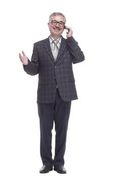 in full growth. smiling elderly man talking on a smartphone . isolated on a white background