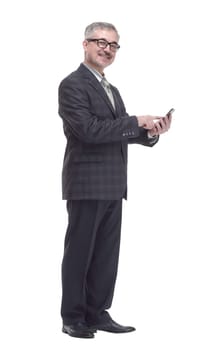 in full growth. smiling elderly man talking on a smartphone . isolated on a white background