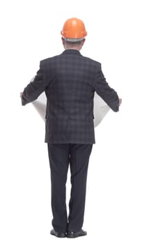 rear view. architect with a drawing standing in front of a white wall. isolated on a white